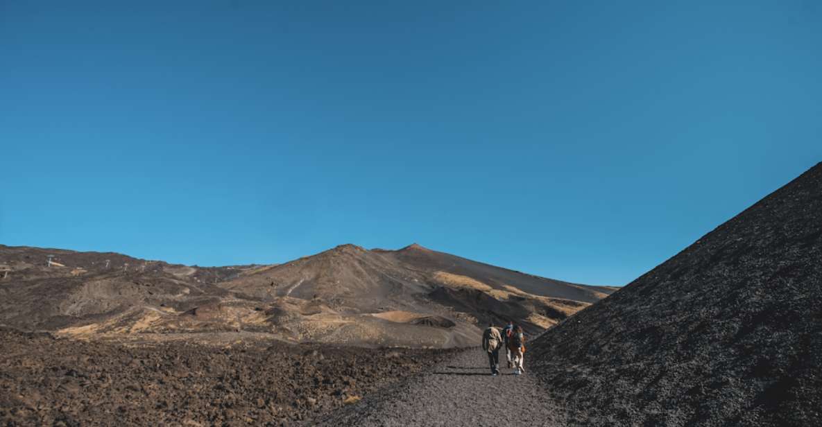 Catania: Etna Morning Excursion with Tasting and Pickup - That guided cave moment: helmet, flashlight, and real volcanic structure