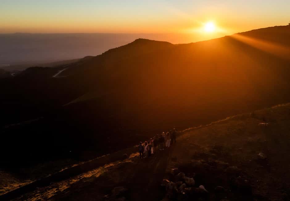 Catania: Etna Sunset Tour with Transfer - Stop 1 to Stop 2: the ride up with a guide in the background