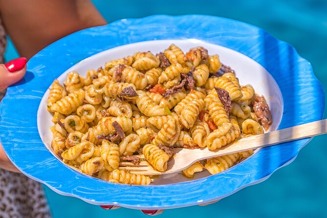 Guided day by boat in Carloforte with snorkelling and aperitif - Punta Delle Colonne: Quick Photos at a Sea Monolith