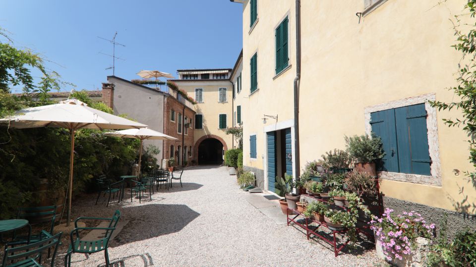 Lazise: Historical Center Wine Tasting Tour - Entering ZF4 Cellar in Lazise: the courtyard cellar vibe