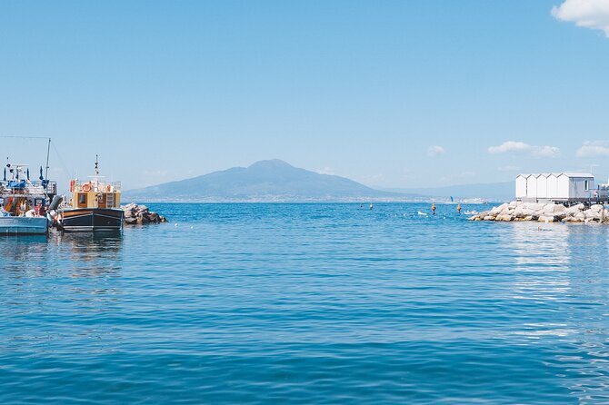 Sorrento Coast Cruise with Limoncello Tasting - Marina di Puolo: fishing boats, clear water, and Capri in the distance